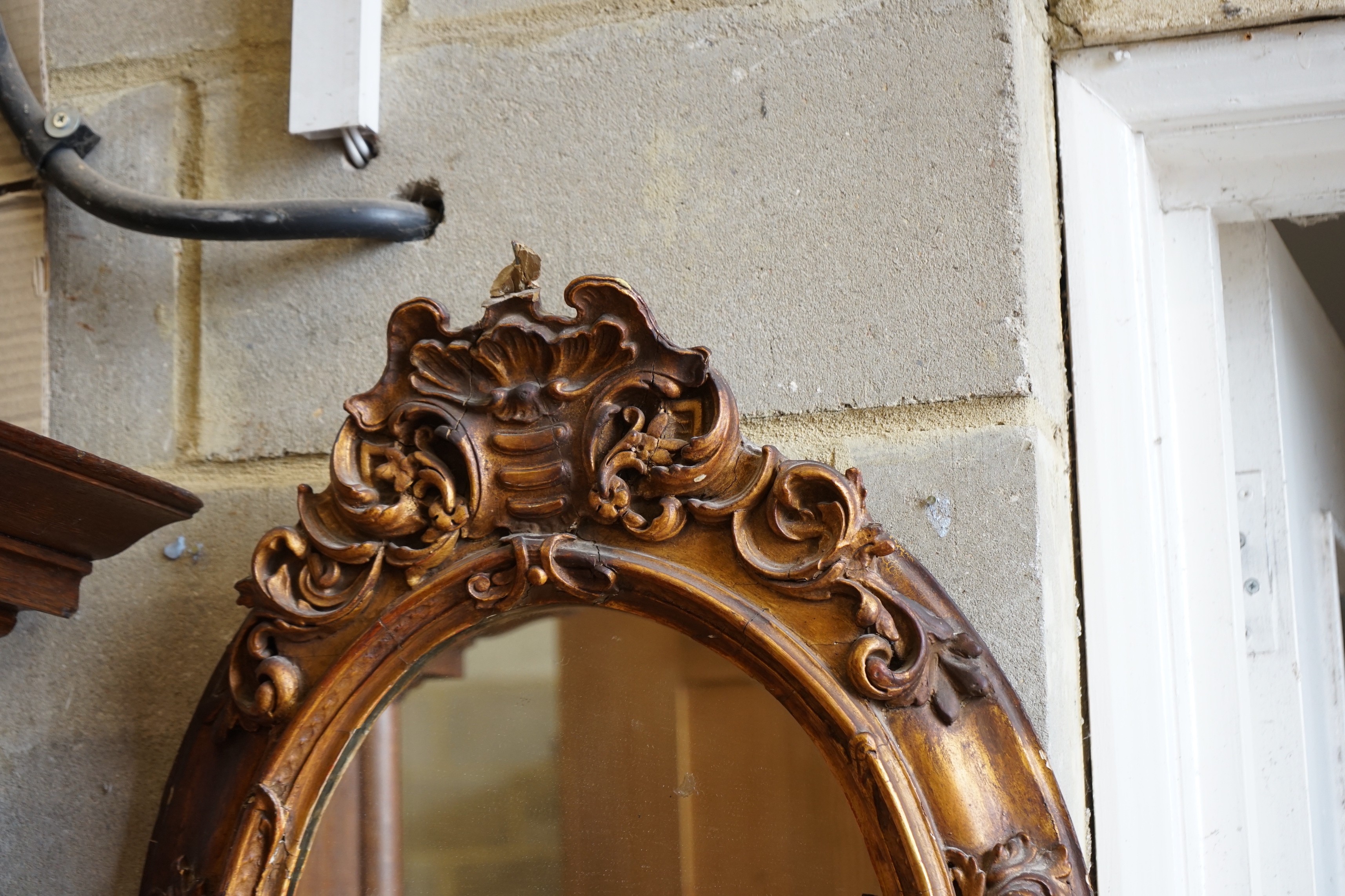 A Victorian giltwood and gesso oval girandole, width 48cm, height 72cm